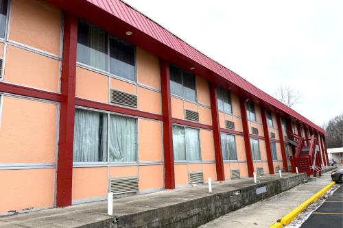 a building with a red and orange at Red Carpet Inn & Suites Lima -Listing Partner in Lima