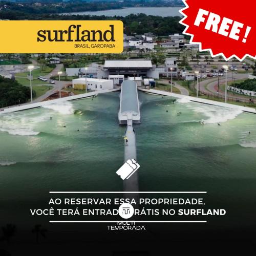 a poster of a river with a boat in the water at Rosa Internacional - Surfland in Praia do Rosa