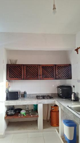 a kitchen with a sink and a counter top at Malindi Sunset Apartments in Malindi