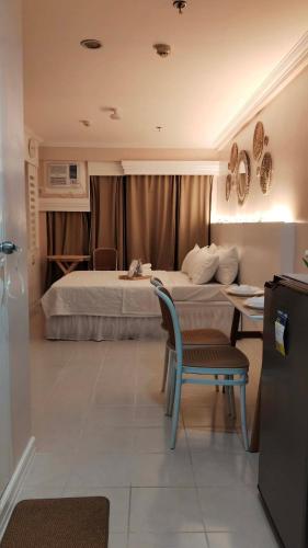 a hotel room with a bed and a table and a chair at Beloved's Homestay in Iruhin