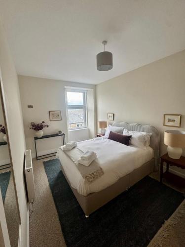 a bedroom with a large bed and a window at The Coastal Haven, Broughty Ferry in Dundee