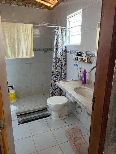 a bathroom with a toilet and a sink at Casa para Carnaval in Olinda