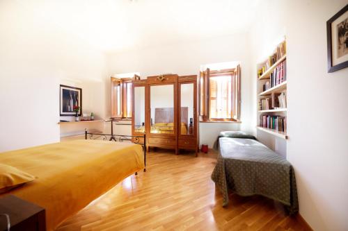 a bedroom with a bed and a book shelf at Palazzo Tronconi agriturismo in Arce