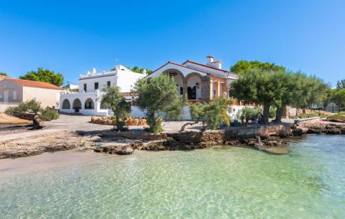a house on the shore of a body of water at Es Clot in Alcudia