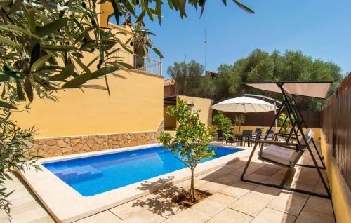 a swimming pool with a chair and an umbrella at Calamari 7 in Portocolom