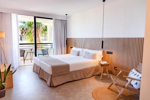 a hotel room with a bed and a balcony at Hotel Eu Bahia Pollença in Port de Pollensa
