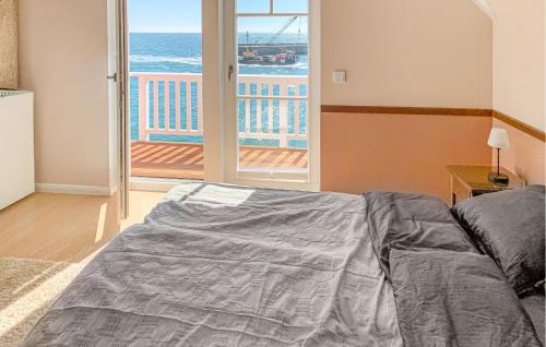 a bedroom with a bed and a view of the ocean at Unendliche See in Olpenitz