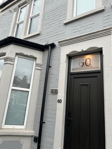 a house with a black door with the number on it at Barratt Street En-Suite Rooms in Bristol