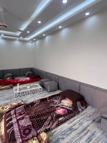 a room with a couch with a blanket on the floor at Local experience in El Quweira