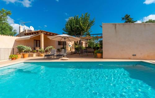 a swimming pool in front of a house at Clonenell in Canyamel