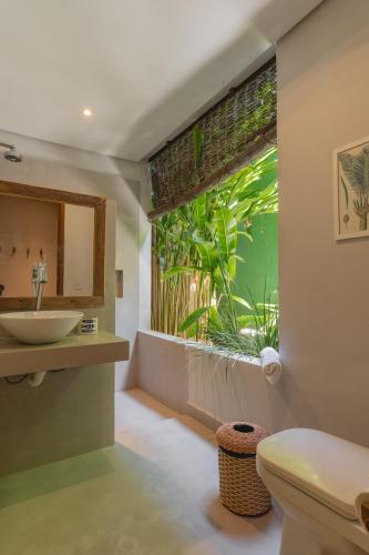 a bathroom with a sink and a window with an aquarium at D'amo Hotel Boutique in Trancoso