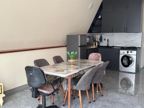 a kitchen with a dining room table and chairs at Boss House in Quba