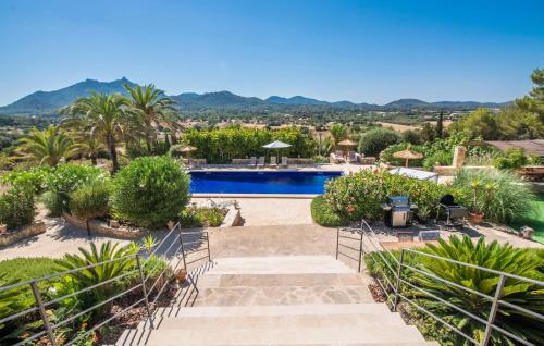 a villa with a pool and mountains in the background at Casa Amorena in Felanitx