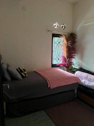 a bedroom with a bed and a window in it at Gandasari Homestay Banyuwangi in Dadapan