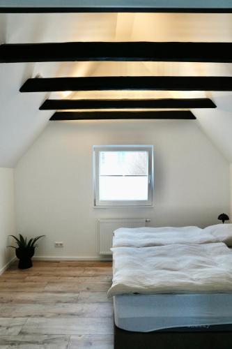a bedroom with a large bed and a window at Altstadt Apartment Chalet in Haltern