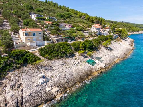 an aerial view of a villa on a rocky island at Seafront Holiday Home - Private Jacuzzi in Blato
