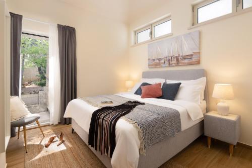 a bedroom with a large bed and a window at Villa Nada - Unique & Artistic in Korčula
