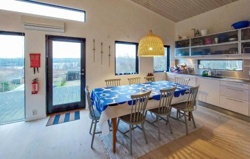 a kitchen and dining room with a table and chairs at Stunning Home In Örkelljunga With Sauna in Orkelljunga