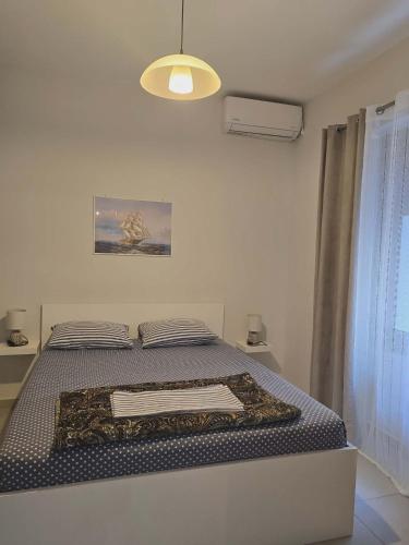 a bedroom with a bed with a blanket on it at A&A Apartment in Piraeus