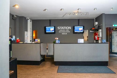 a waiting room with two monitors on the wall at Station - Hostel for Backpackers in Cologne