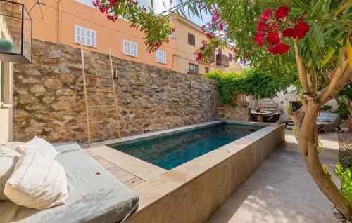 a swimming pool in front of a building at Casa Max in Artá