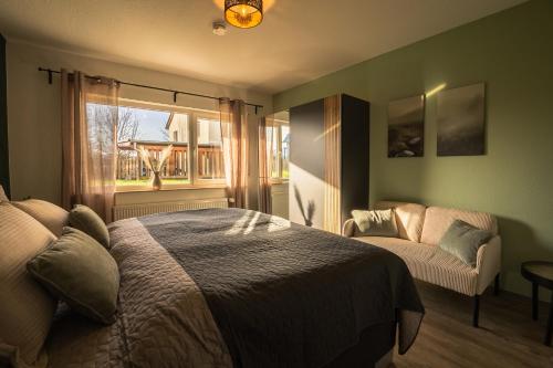 a bedroom with a bed and a chair and a window at Hannas Lieblingsplatz in Marburg an der Lahn