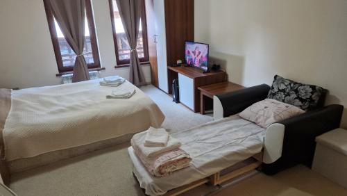 a hospital room with a bed and a chair at Studio Kalina Green Life in Pamporovo