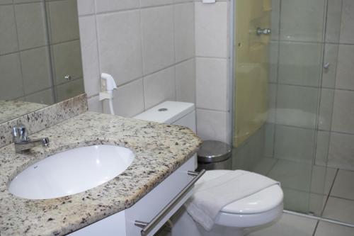 a bathroom with a sink and a toilet and a shower at TerrazzoPontaNegraDJ in Natal