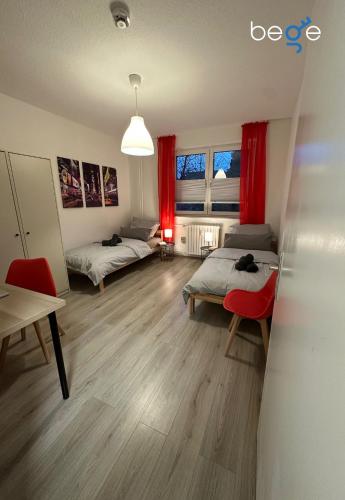 a living room with two beds and a table at BEGE APARTMENTS Next Level Sleep in Niederdorla