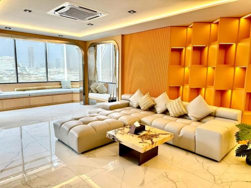 a living room with a couch and a table at The Prestige Living Bangkok at Sathorn-Chan in Bangkok