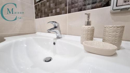 a white sink with a faucet and a bottle of soap at Residenza Magnolia in Tropea