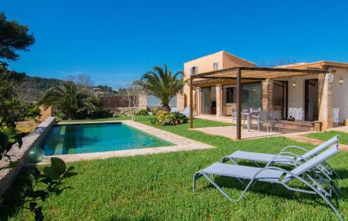 a villa with a swimming pool and a house at Ca Ses Nines in Cala Bona