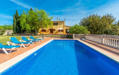 a swimming pool with chairs and a house at Sa Vileta in Sencelles