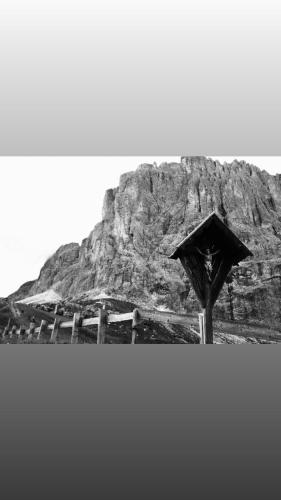 a black and white photo of a mountain with an umbrella at Hotel Panorama in Cavalese