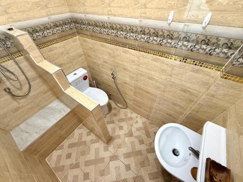 a bathroom with a toilet and a sink at Coastal Nomad Ocean View Stay - 1 or 2 Rooms in Ban Pak Khlong Phe
