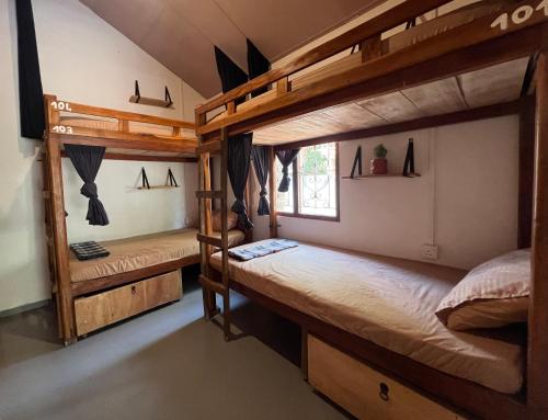 a room with two bunk beds and a window at C U Hostel in Trincomalee