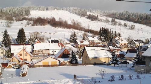 a small town covered in snow with houses at Kolnicka Krahule in Krahule