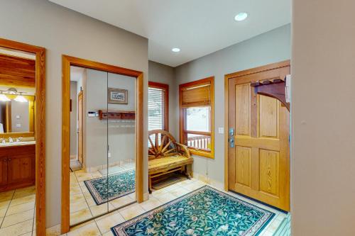 a bathroom with a shower and a wooden door at Coyote Creek Chalet in Big White