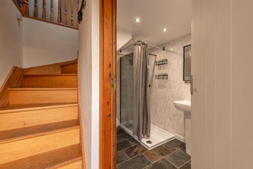 a bathroom with a shower and a sink at Silverwood Stylish House - Pass the Keys in Telford
