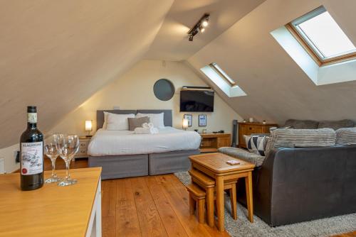 a living room with a bed and a wine bottle at Silverwood Stylish House - Pass the Keys in Telford