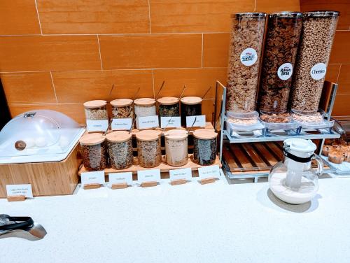 a display of jars of food next to a bath tub at SpringHill Suites by Marriott Houston Rosenberg in Rosenberg