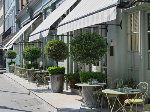 a row of tables and chairs outside of a building at Charlotte Street Hotel, Firmdale Hotels in London