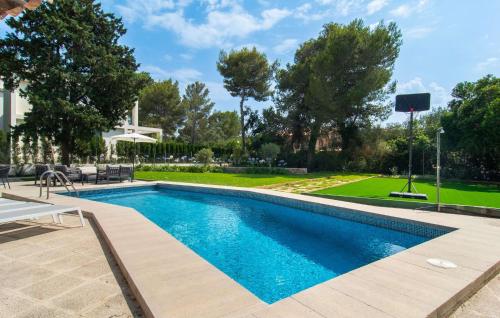 a swimming pool in a yard with a basketball court at El Tulipan Blanco in Alcudia