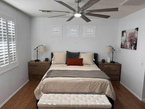 a bedroom with a large bed with a ceiling fan at Homes by Abby LLC in Maricopa