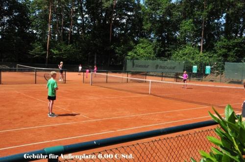 a group of people playing tennis on a tennis court at Hasenfeldlodges in Sögel