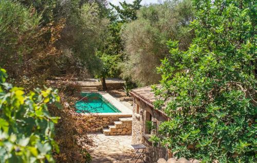 a swimming pool in the middle of a garden with trees at Moli Den Guixo in Artá