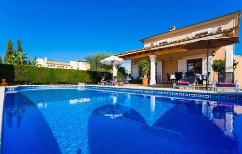 a swimming pool in front of a house at Gatoses in Sa Coma