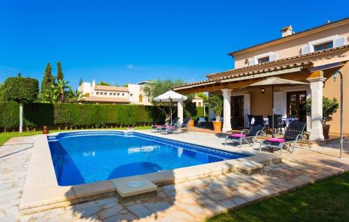 a swimming pool in the backyard of a house at Gatoses in Sa Coma