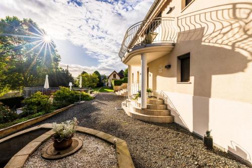 a house with a balcony on the side of it at Elbvilla Pirna mit Sauna und Kamin mit privatem Zugang zur Elbe in Pirna