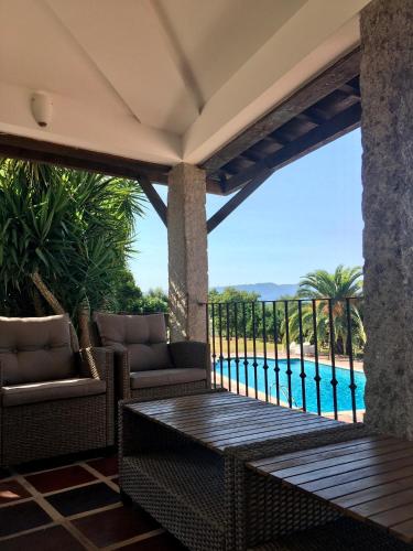 a patio with a view of a swimming pool at The Hideaway at Quinta de Moçamedes - Suites & Apartments in Vouzela